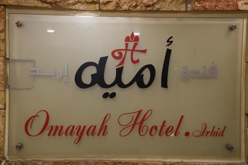 um sinal para o hotel do Hospital Anushka numa parede em Omayah hotel irbid em Irbid