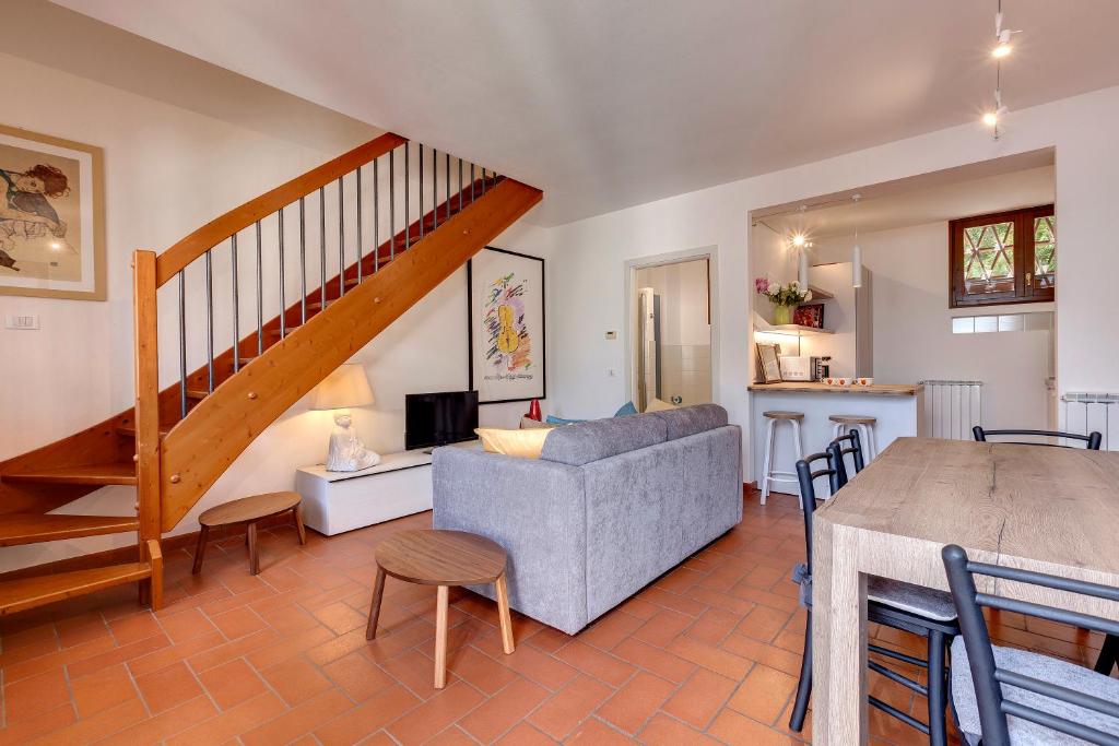 a living room with a couch and a staircase at Poggio Imperiale Apartment by Mamo Florence in Florence