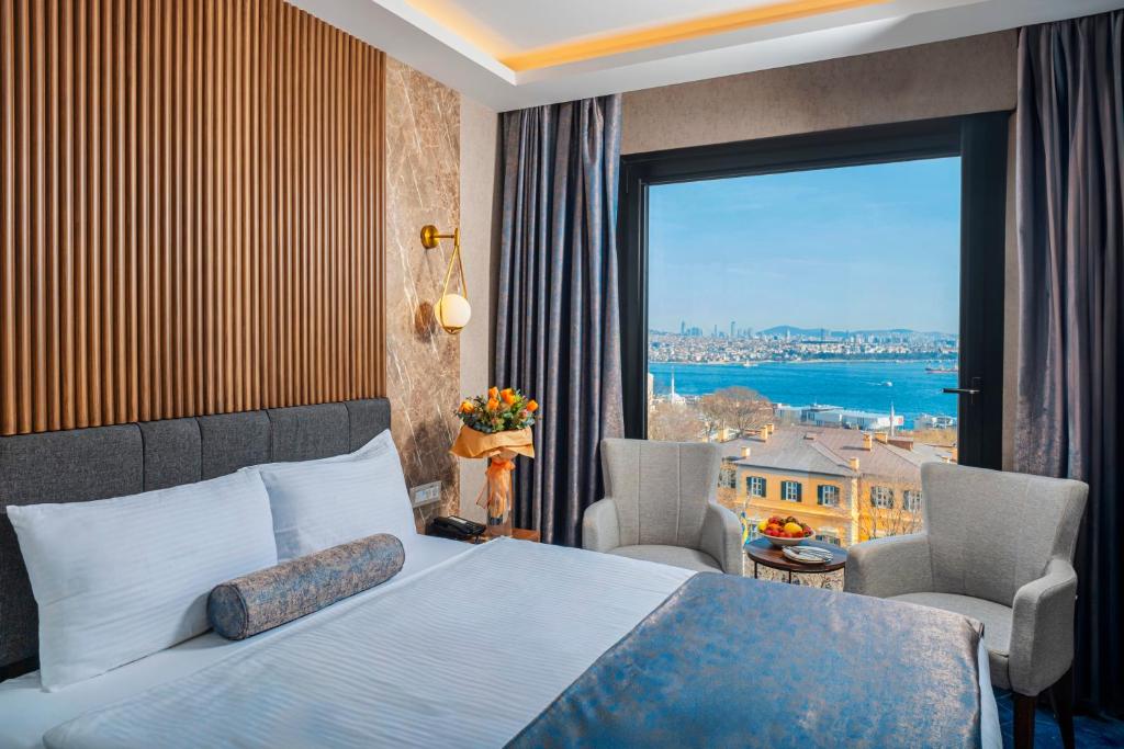 a hotel room with a bed and a large window at Ring Stone Hotels Bosphorus - Special Class in Istanbul