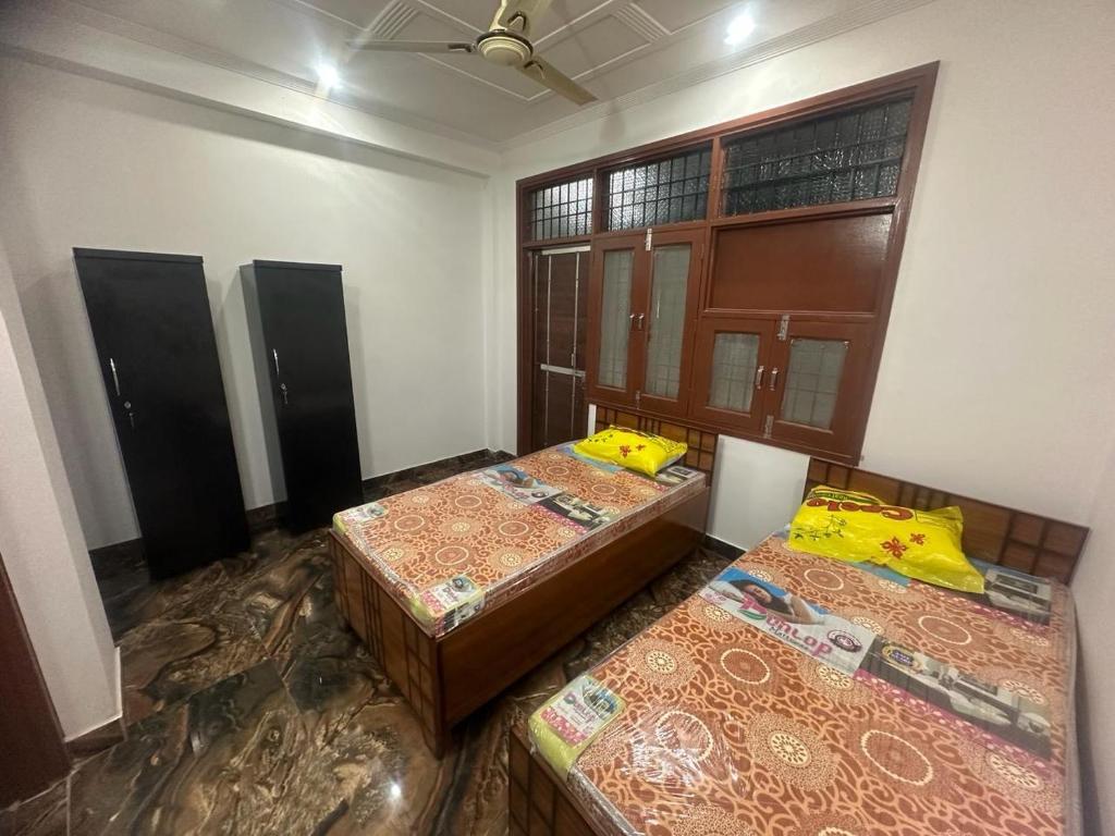 a room with three beds in a room at PG for girls in New Delhi