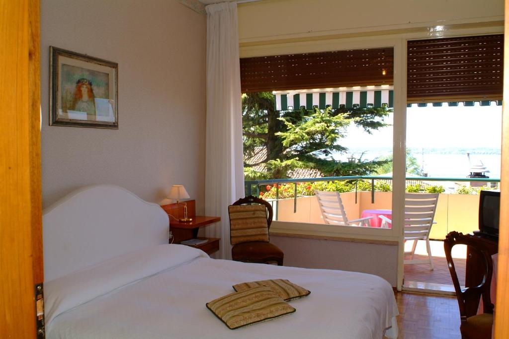 Postel nebo postele na pokoji v ubytování Hotel Broglia
