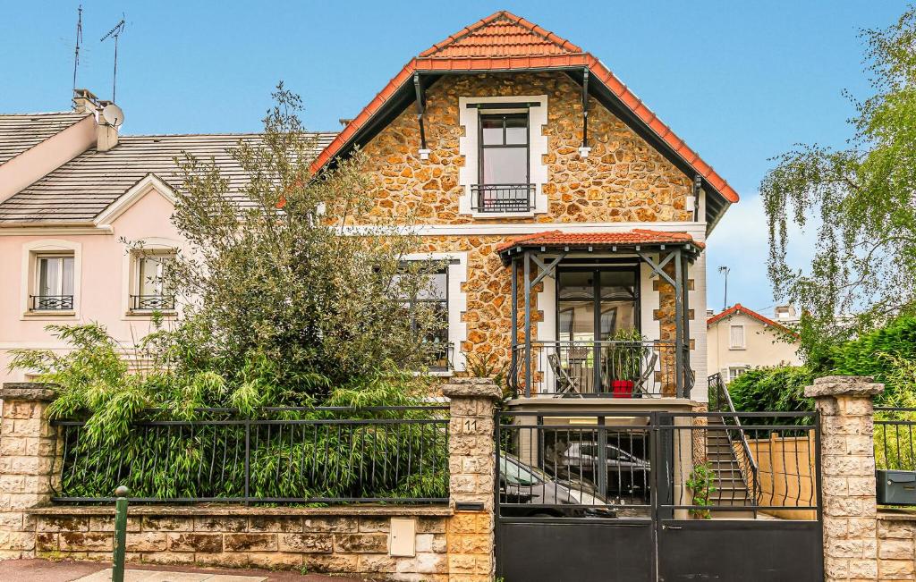 une vieille maison avec un portail devant elle dans l'établissement Nice Home In Bourg-La-Reine With Wifi, à Bourg-la-Reine
