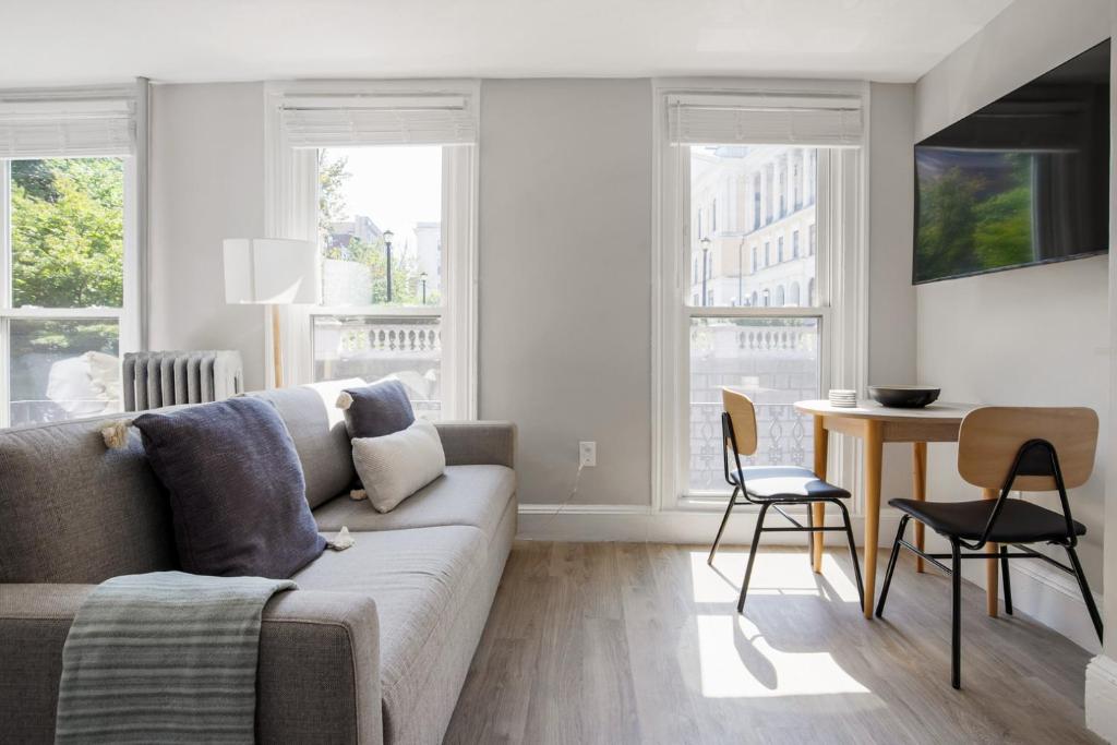 a living room with a couch and a table and chairs at Beacon Hill studio nr boston common shops BOS-906 in Boston