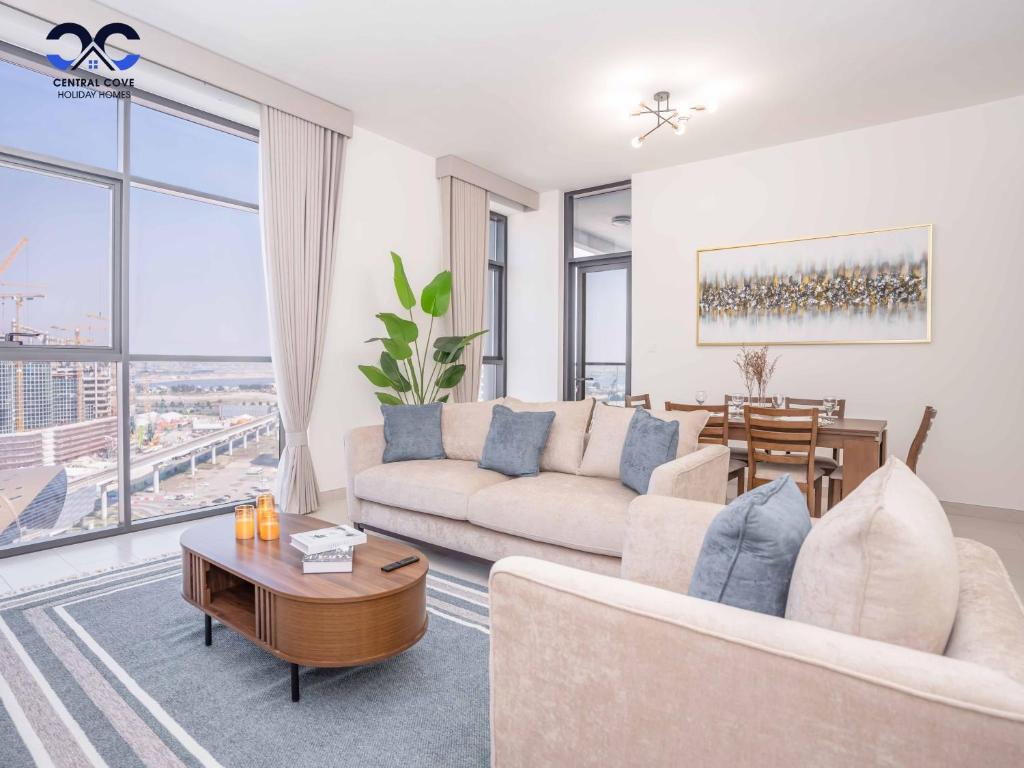 a living room with a couch and a table at Sleek & Stylish Brand New 1-BR Apt - Jaddaf Avenue in Dubai