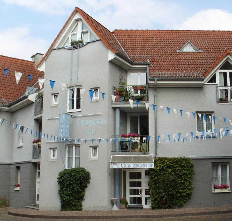 a building with blue and white flags on it at Hotel Cronberger Hof in Ladenburg