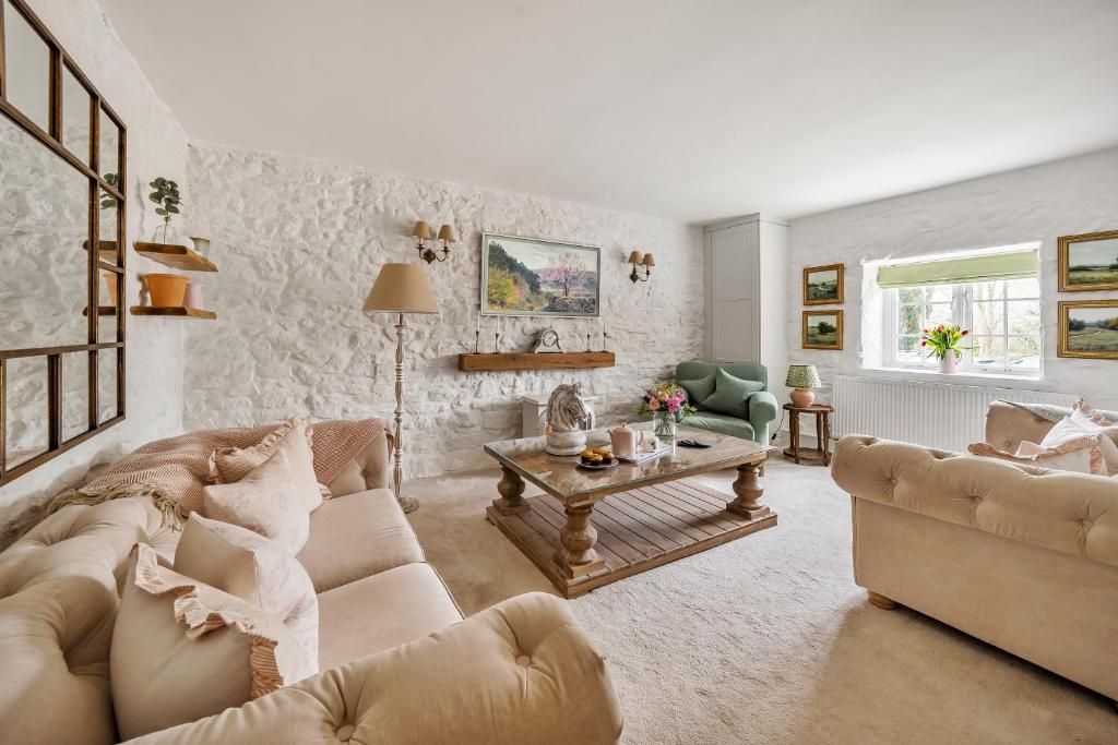 a living room with a couch and a table at Live the coastal cottage dream in Dorset AONB in Weymouth