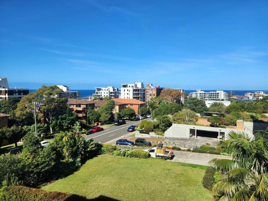 a view of a city with the ocean in the background at Beach Pad at North Wollongong in Wollongong