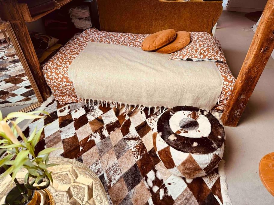 a bed with a quilt and two donuts on it at Superbe duplex loft au coeur de Paris in Paris