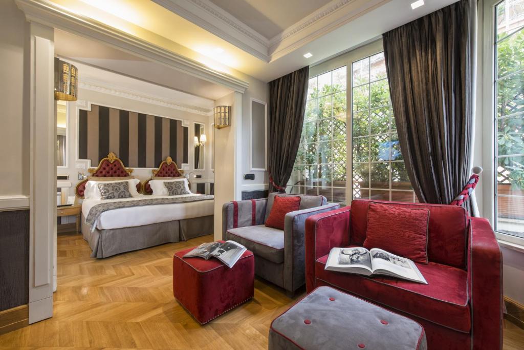 a hotel room with a bedroom and a bed at The Britannia Hotel in Rome