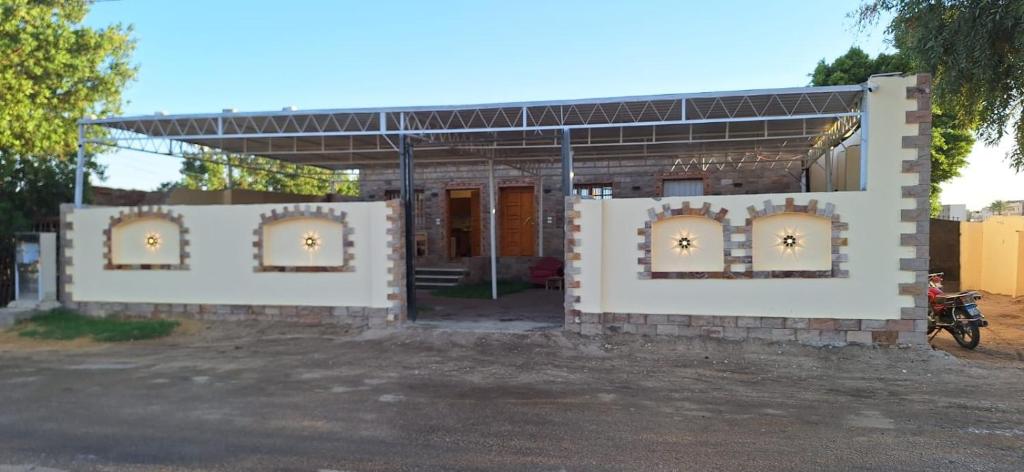 a building with two gates in front of it at Amenhoteb House in Luxor