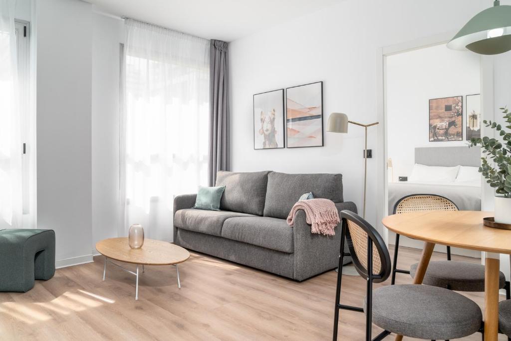 a living room with a couch and a table at Limehome Valencia Carrer d'Antonio Ferrandis in Valencia