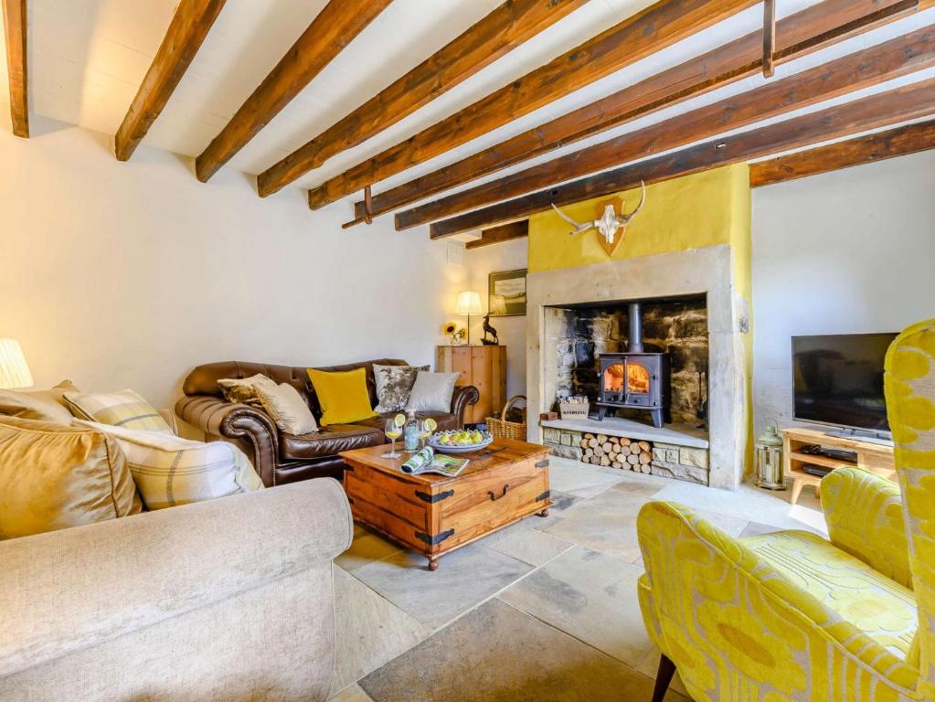 a living room with a couch and a fireplace at 3 Bed in Harbottle 75083 in Harbottle