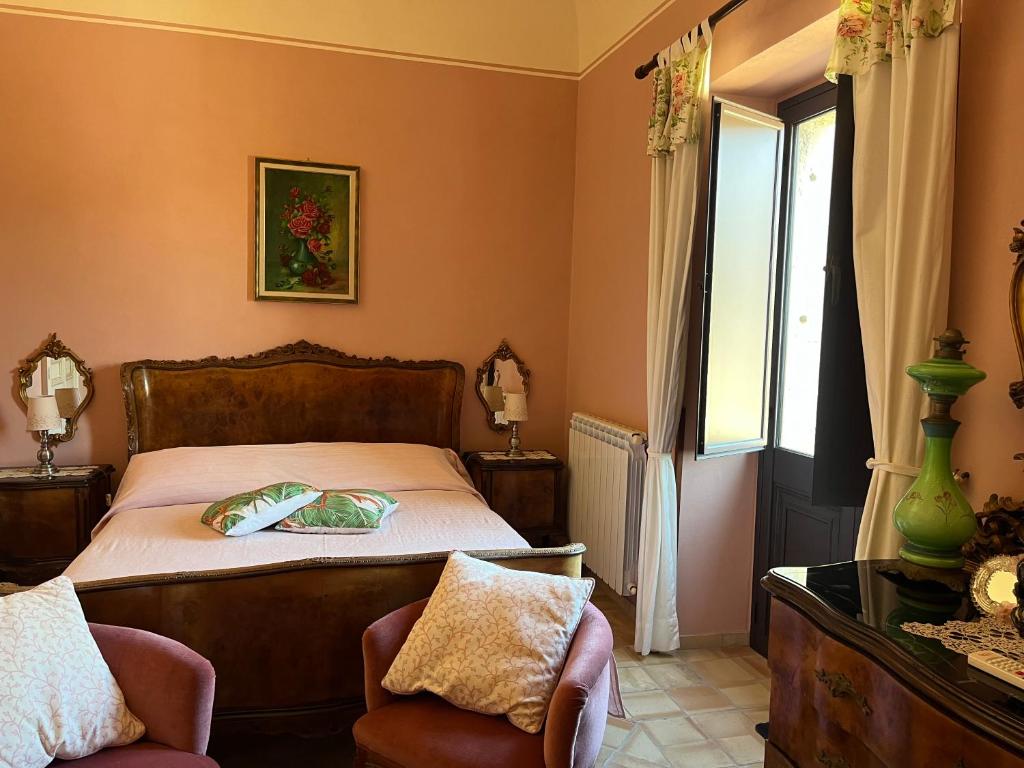 Postel nebo postele na pokoji v ubytování Palazzo Cutrufelli