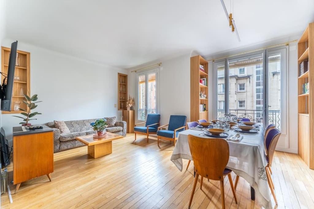 een woonkamer met een tafel en een bank bij Appartement cosy à 5min de Paris in Saint-Mandé