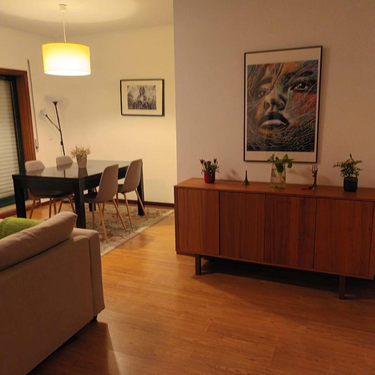 a living room with a table and a dining room at Casa Familiar Porto in Porto