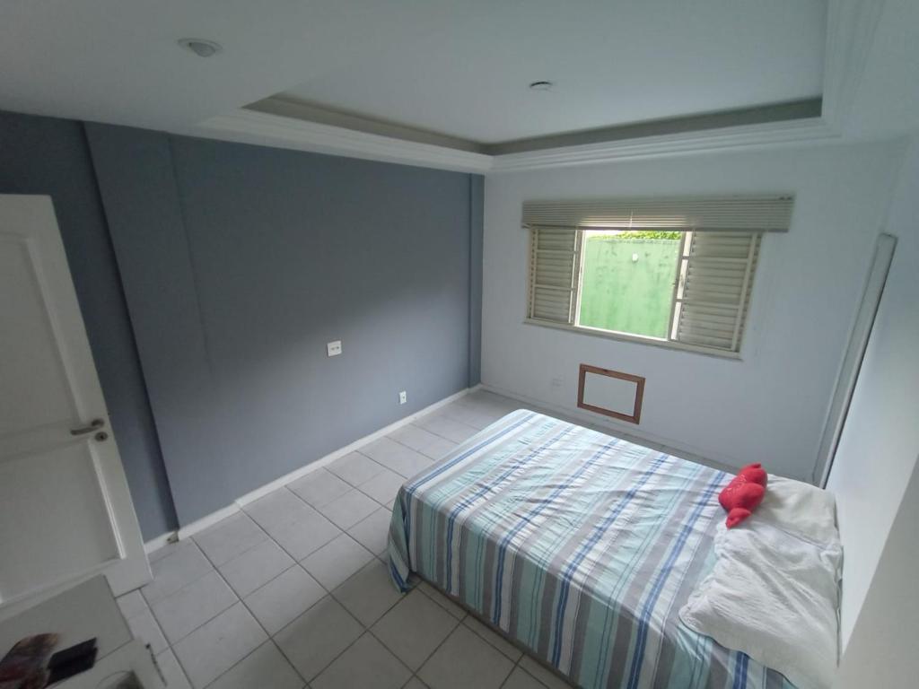 a bedroom with a bed and a window at Cantinho do Sossego in Rio de Janeiro