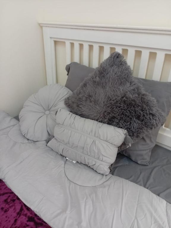 einem Stapel Kissen auf einem Bett in der Unterkunft غرفة دور ارضي in Sakaka
