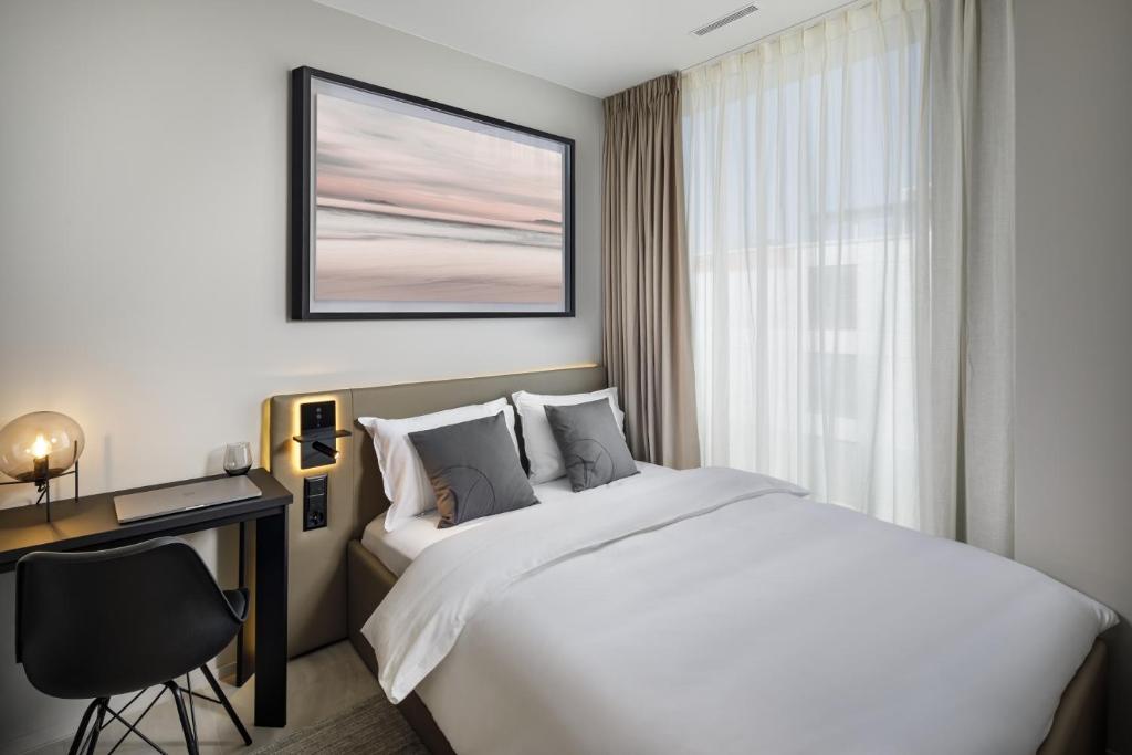 Postel nebo postele na pokoji v ubytování VISIONAPARTMENTS Glattbrugg - contactless check-in