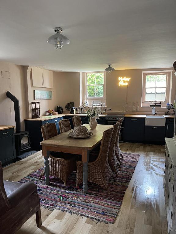 a kitchen with a table and chairs in a room at Stunning 2-bedroomed Cottage in Cockermouth