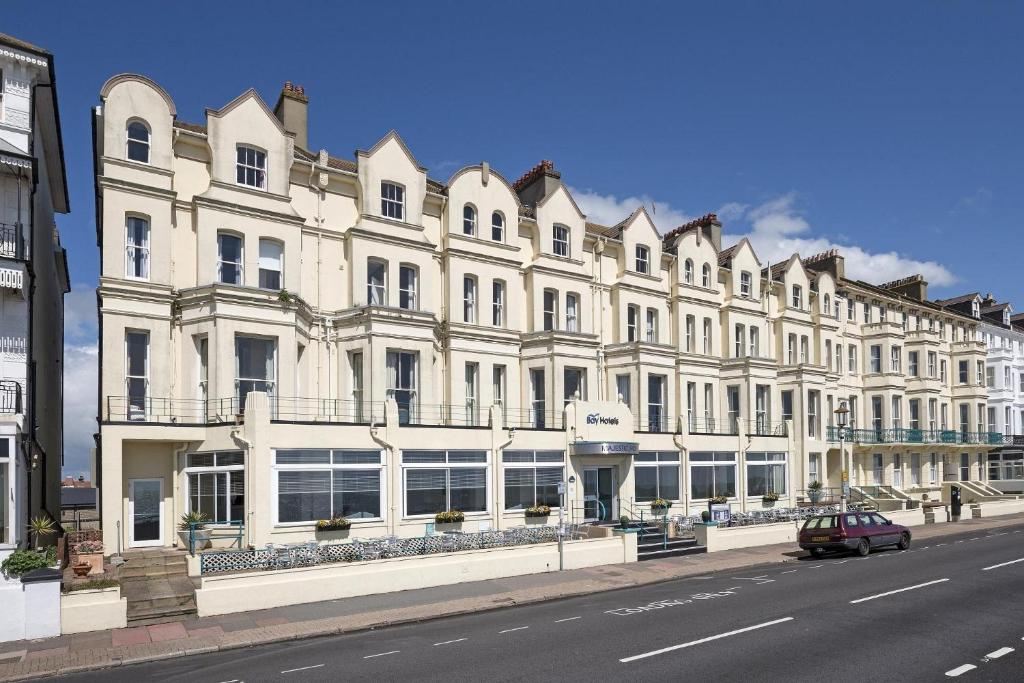 a large white building on the side of a street at The Majestic Hotel in Eastbourne