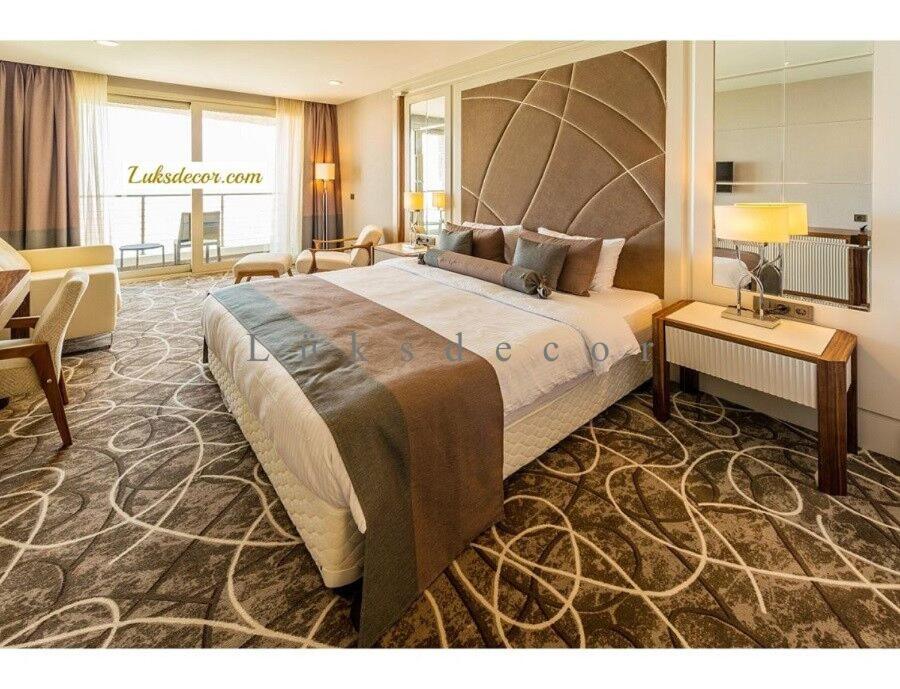 a bedroom with a large bed and a living room at LİMAN OTEL in Istanbul