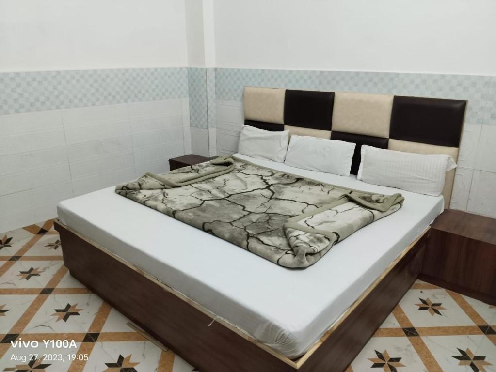 a bed in a small room with a mattress at Raghav guest house in Mathura