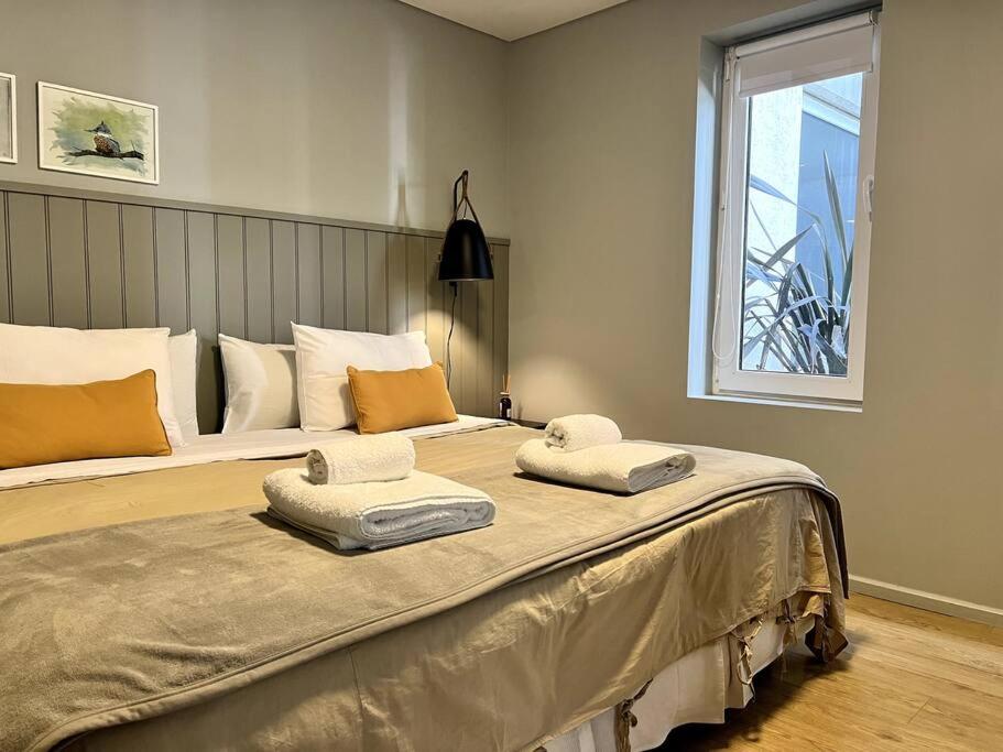 a large bed with two towels on top of it at Seaport Apartments Pacifico H in Ushuaia