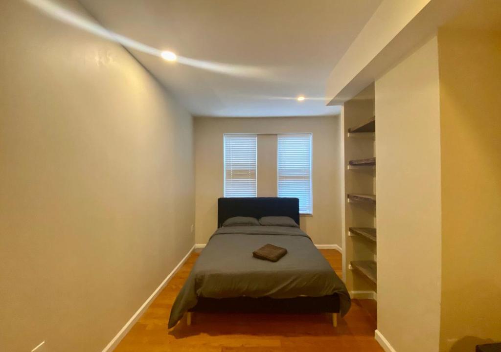 a small bedroom with a bed and a window at Historic Townhouse Oasis with En-suite Bathroom in Philadelphia