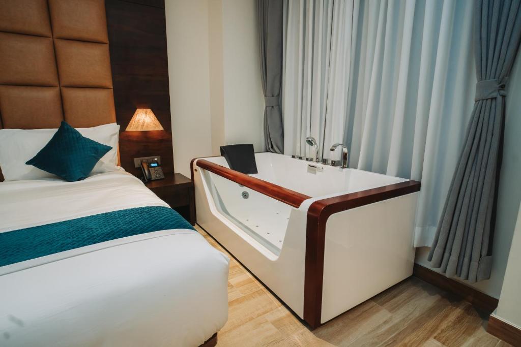 Postel nebo postele na pokoji v ubytování Dees Boutique Hotel