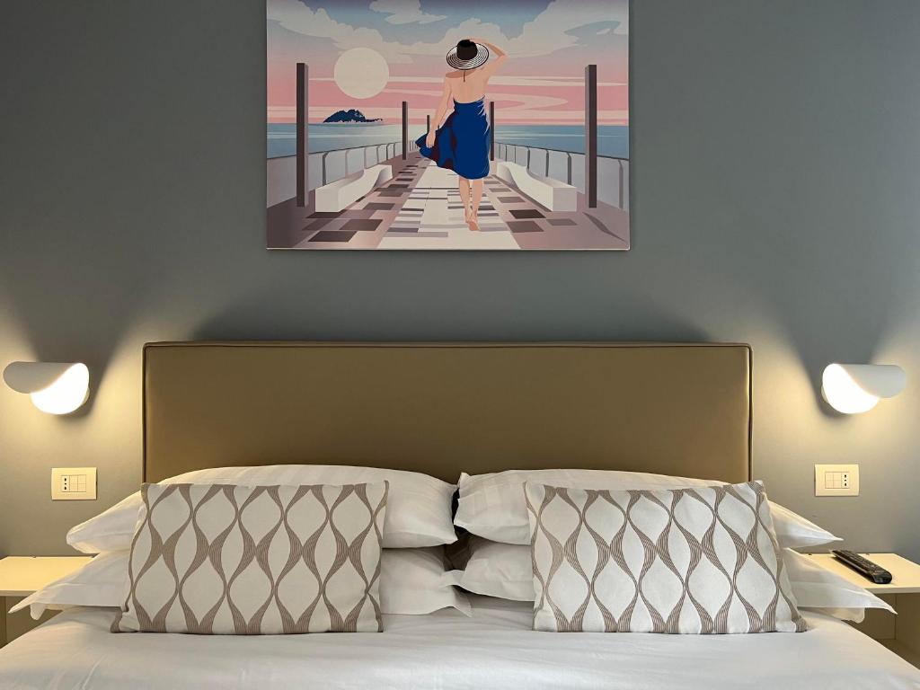 a painting of a woman standing on a pier at Adelasia al Corso in Alassio