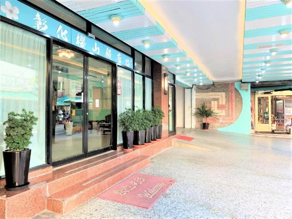 a store front with potted plants in a building at Inn Sun Hotel in Changhua City