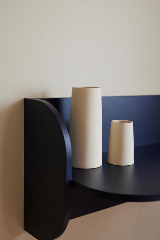 a black shelf with two paper towels on it at Hotel des Victoires - Restaurant in Cannes