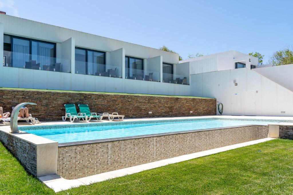 a swimming pool in the backyard of a house at Quinta Solar da Portela in Almodôvar