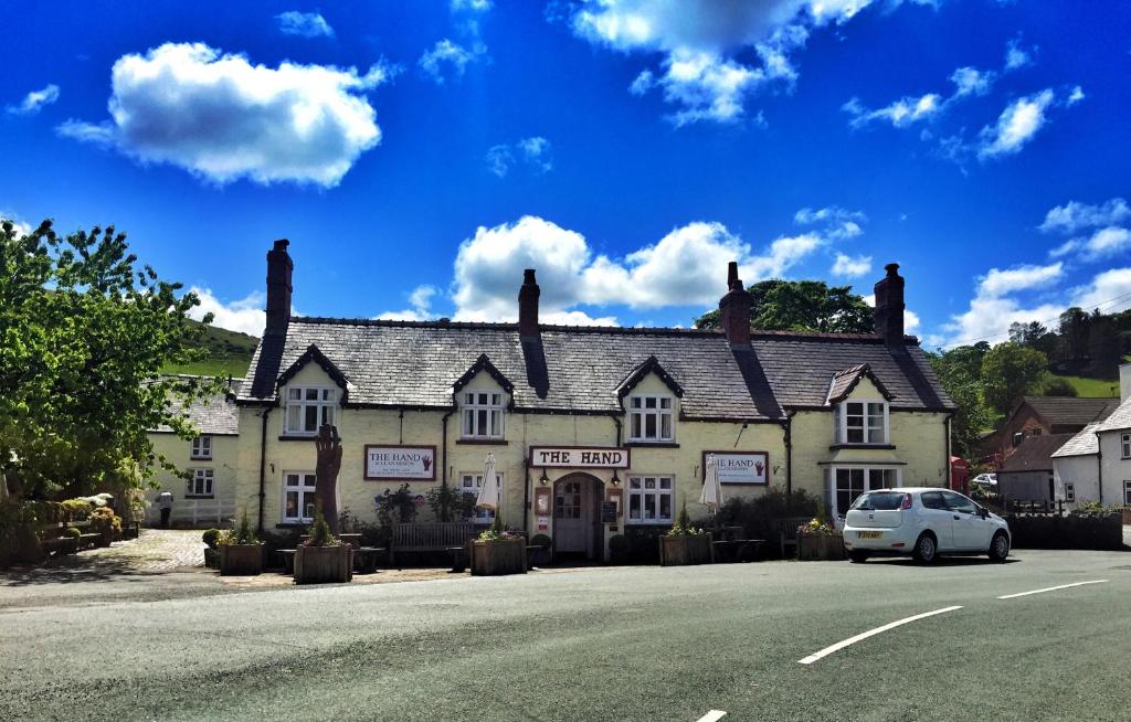 a white car parked in front of a building at The Hand at Llanarmon in Llanarmon Dyffryn-Ceiriog