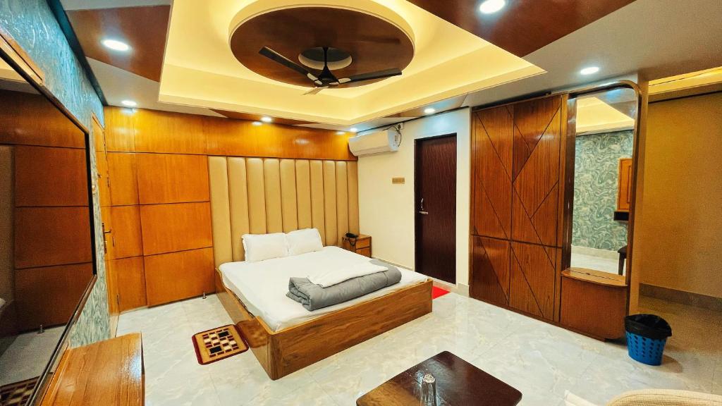 a small room with a bed and a ceiling at Hotel Sonar Bangla in Rāngāmāti