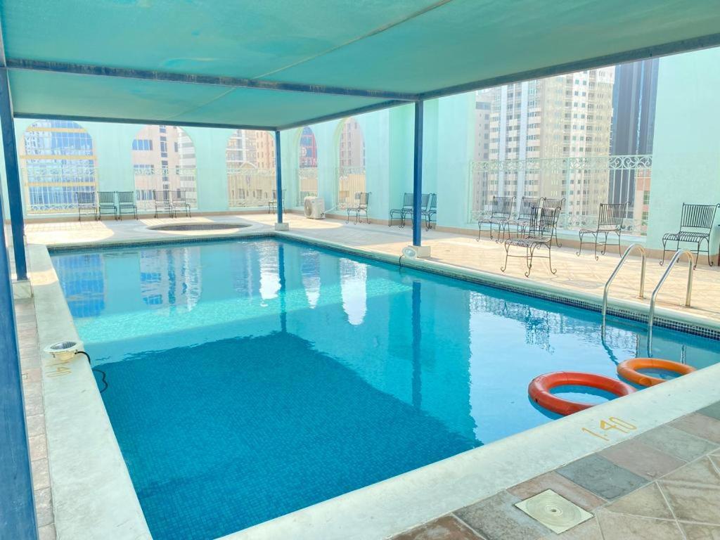 a swimming pool on the roof of a building at Blue Horizon Suites in Manama