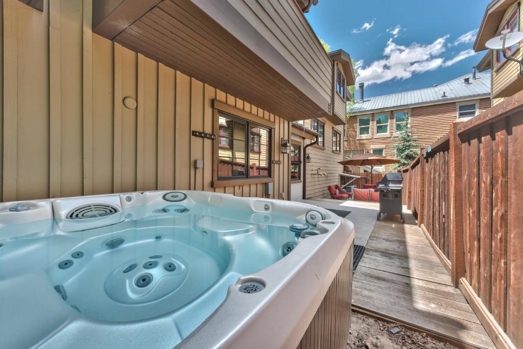 a jacuzzi tub in the backyard of a house at Badgerland Park City - Summer Escape with Year-Round Recreation, Mountain Trail and Private Hot Tub! in Park City