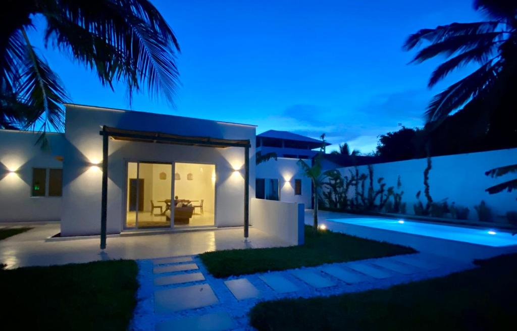 a villa with a swimming pool at night at Lions Villa Zanzibar with private pool - LUXURY ON THE SEASIDE in Kiwengwa