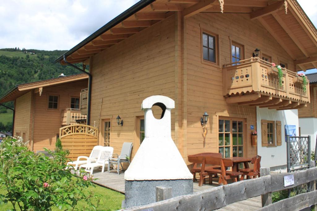 a house with a statue in front of it at Alpen Chalets Zell am See in Niedernsill