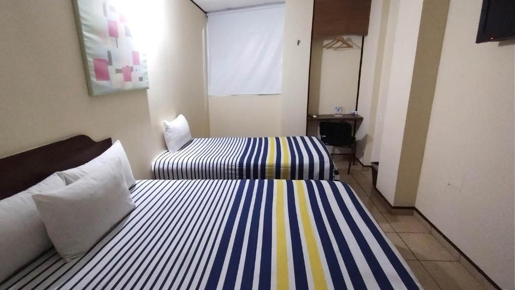 Postel nebo postele na pokoji v ubytování Hotel Mateos 1215
