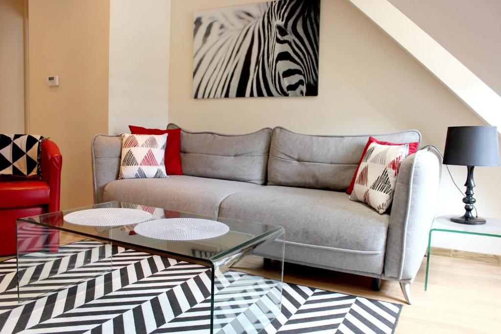 a living room with a couch and a zebra painting at Apartament 007B pod Śnieżką in Karpacz
