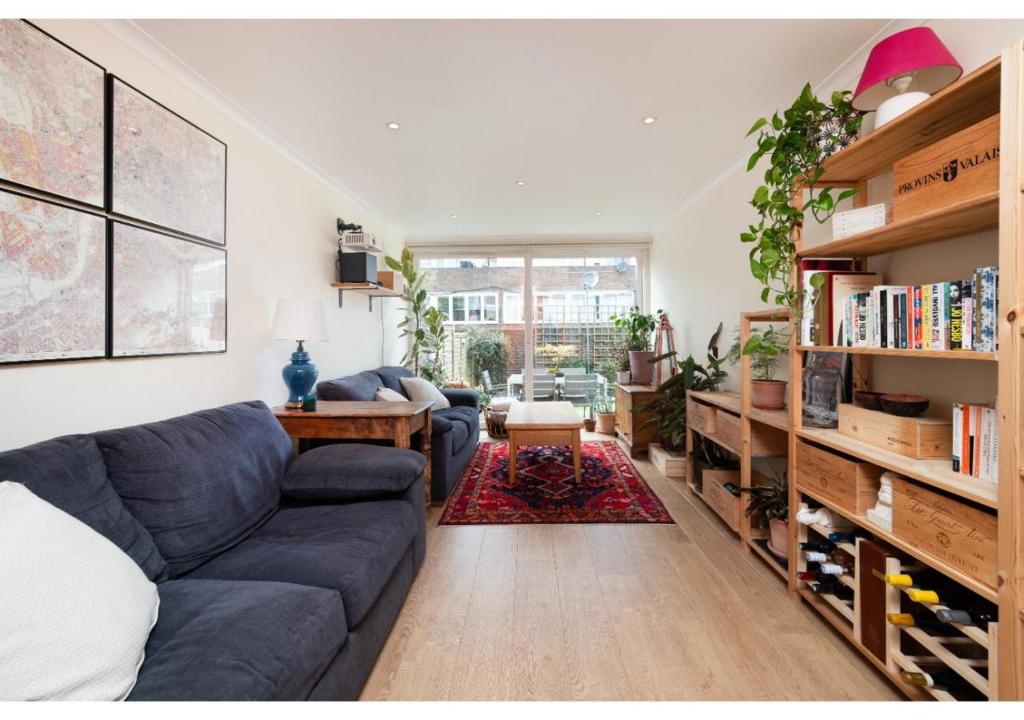 a living room with a couch and a table at chic 3-BR home welll located in Islington in London