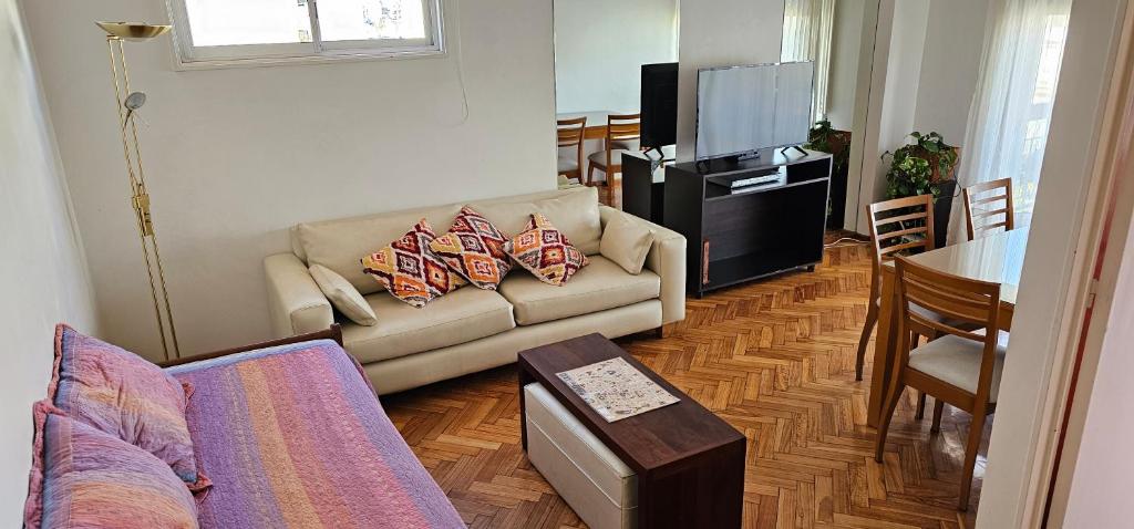 a living room with a couch and a television at Abasto Rent Apart in Buenos Aires