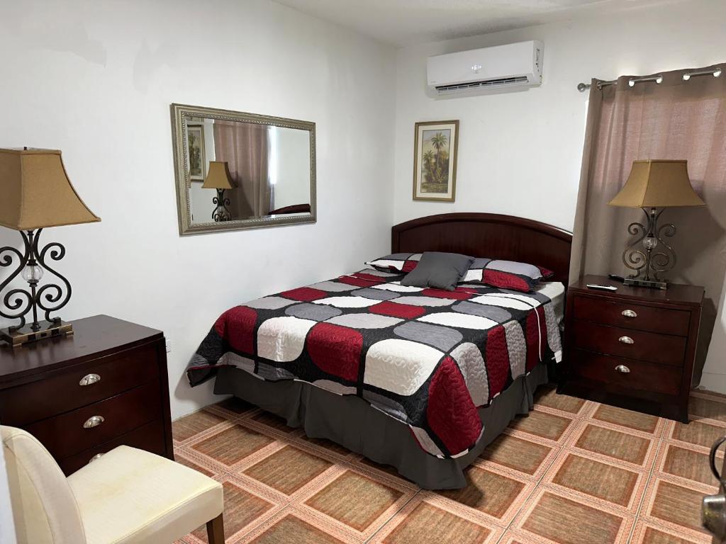 a bedroom with a bed and a mirror and a chair at Spacious Unit with 5BR, 3BA Perfect for Big Groups, Near Ocean Park Beach in San Juan