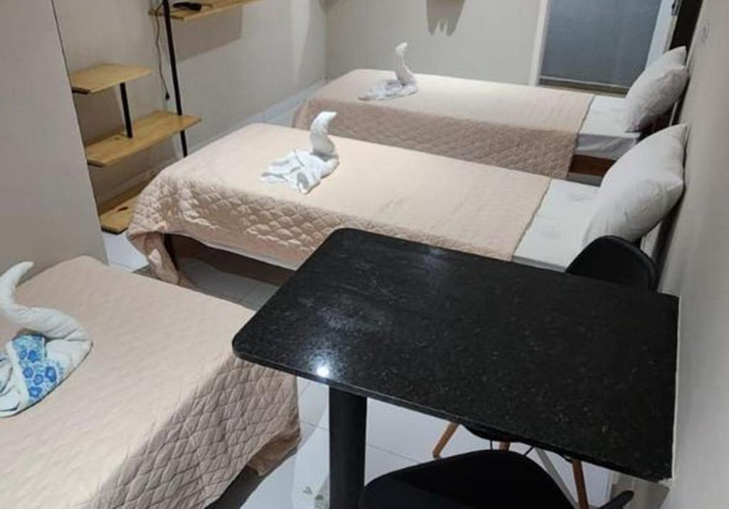 Een bed of bedden in een kamer bij BOB Suítes