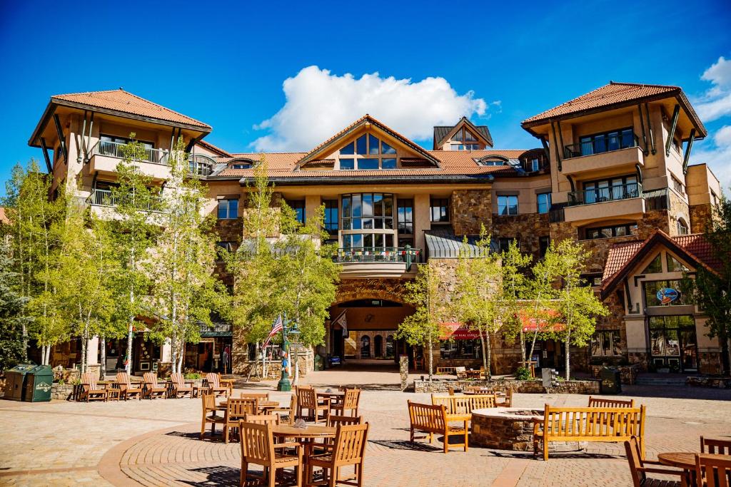 a large building with tables and chairs in front of it at Fairmont Heritage Place, Franz Klammer Lodge in Telluride