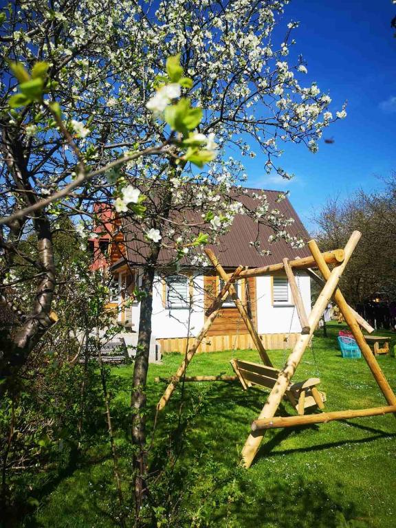a wooden play structure in a yard with a tree at U Bieńka in Biały Dunajec