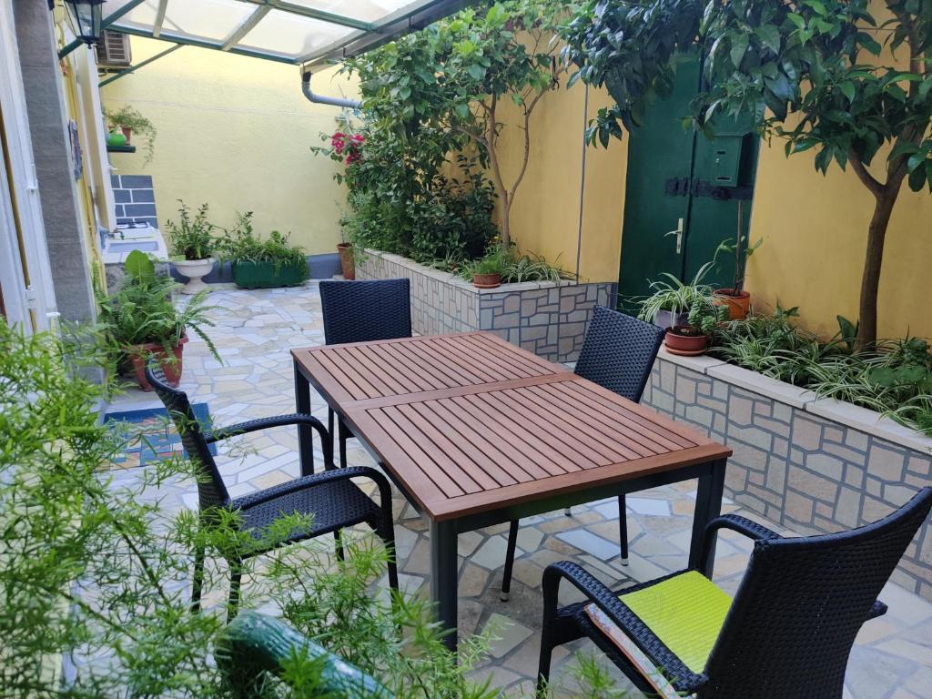 a wooden table and chairs on a patio at Apartman Jadranka in Veli Lošinj
