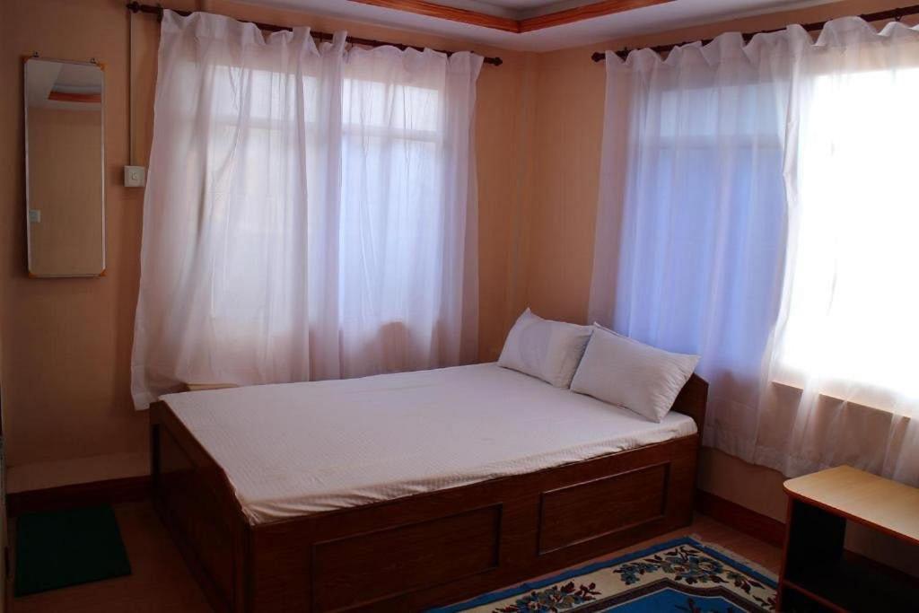 Ένα ή περισσότερα κρεβάτια σε δωμάτιο στο Sunrise View Homestay
