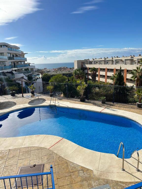 a swimming pool with a view of a building at Panoramic Seaview in Mijas